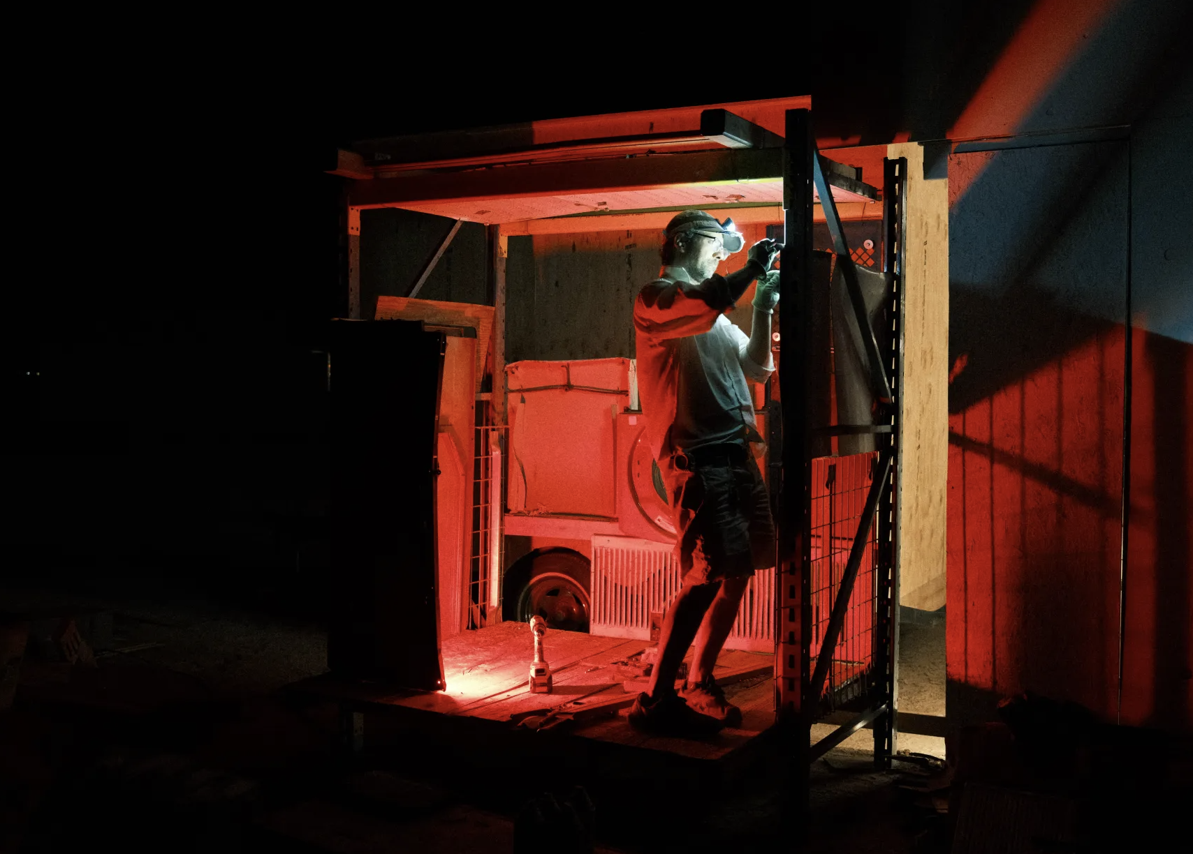 Night work under a red headlamp glow