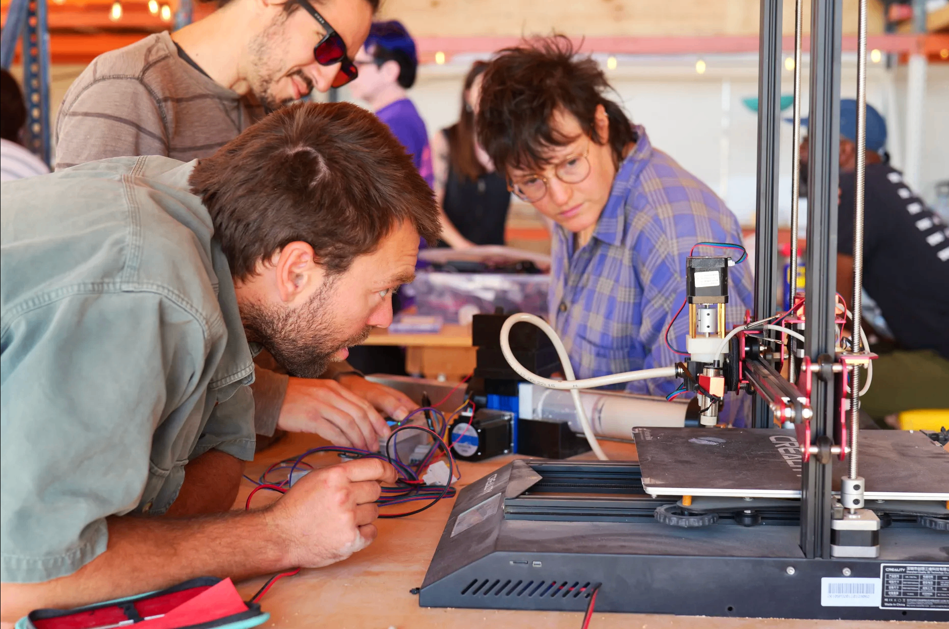 Residents tinkering with a 3D printer in the workshop