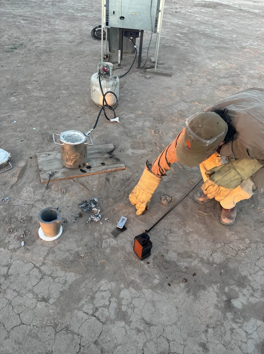 Pouring molten metal at the outdoor foundry